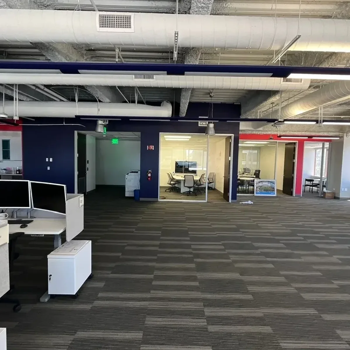 Open workplace with glass conference rooms and color-blocked walls
